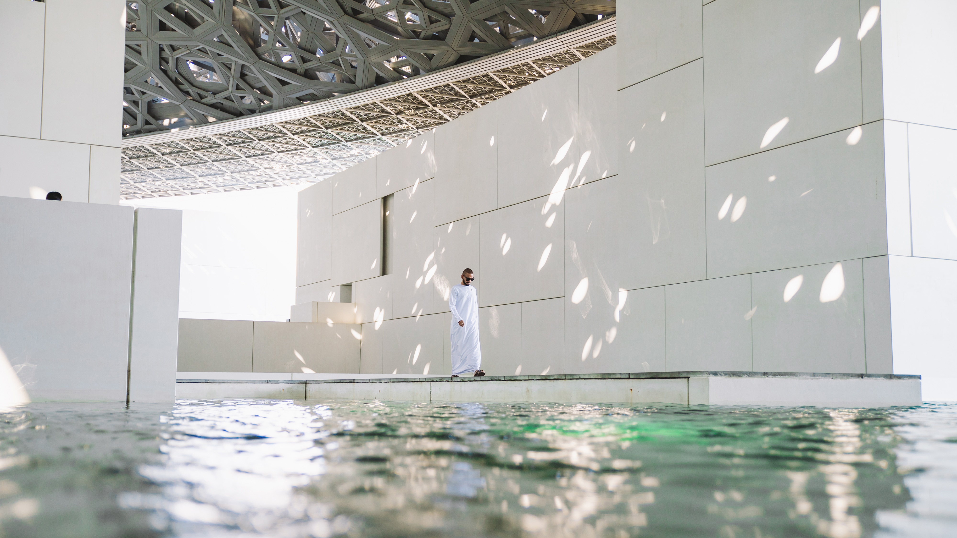 A person beside an indoor pool at W Abu Dhabi — Yas Island