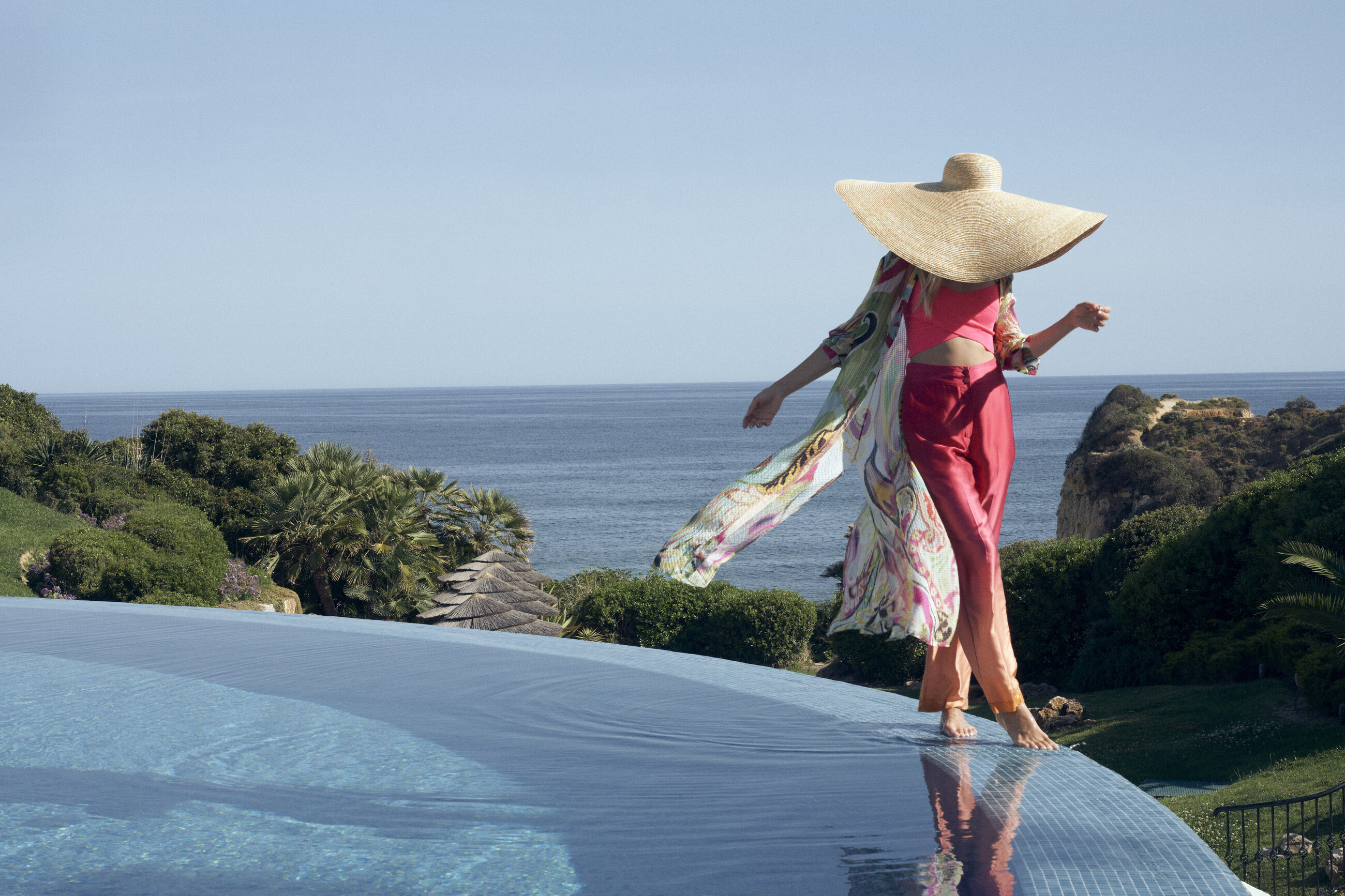A guest beside the pool at VILA VITA Parc, overlooking the Atlantic