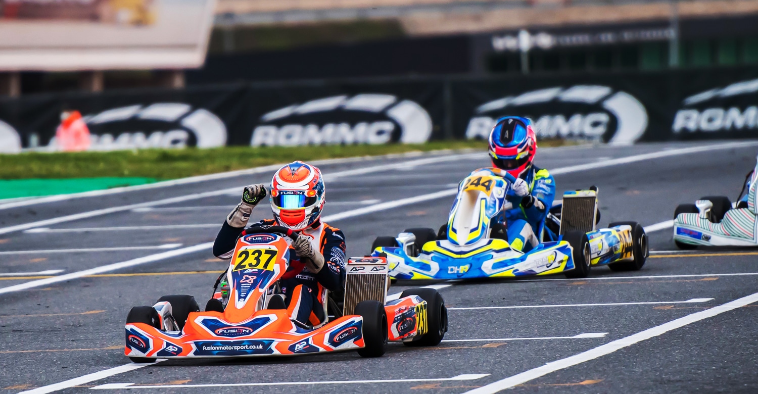 Competition karts at Kartódromo Internacional do Algarve, drivers’ faces obscured by visors