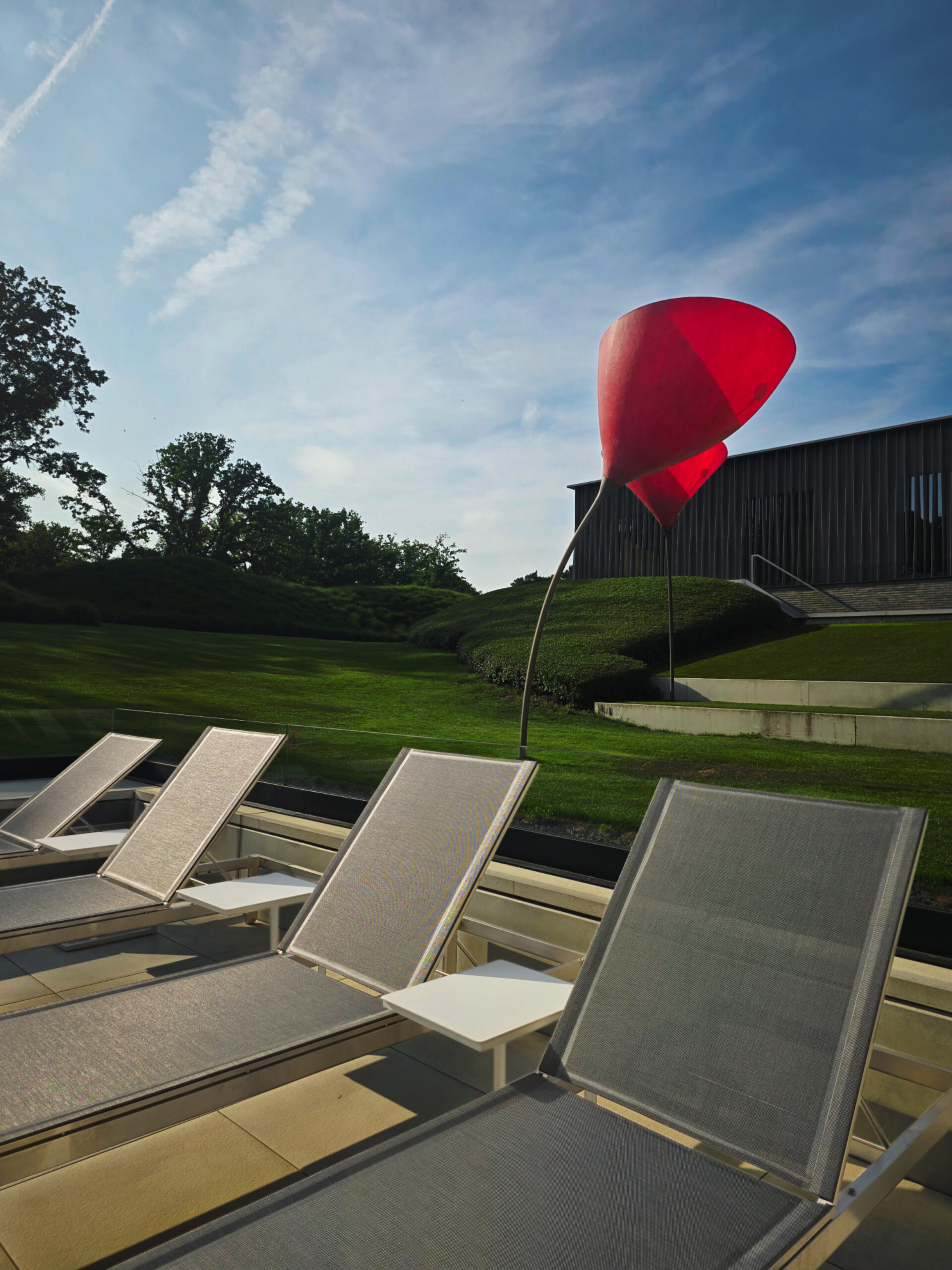 Loungers and garden sculpture at La Butte aux Bois