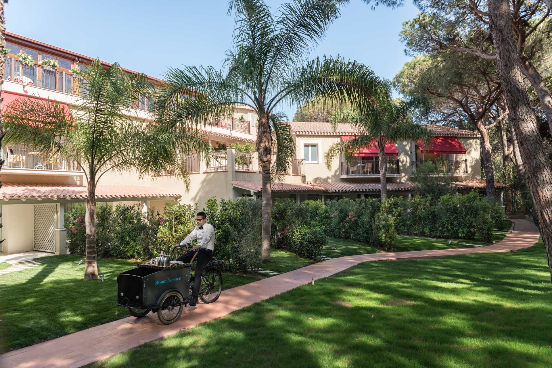 Villa del Parco buildings and gardens, with a room-service bicycle
